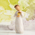 Willow Tree Keepsake, 5.5”h hand-painted standing resin figure in cream dress, holding gold-leaf heart against chest, in front of light green painting