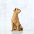 Golden dog sitting down figurine