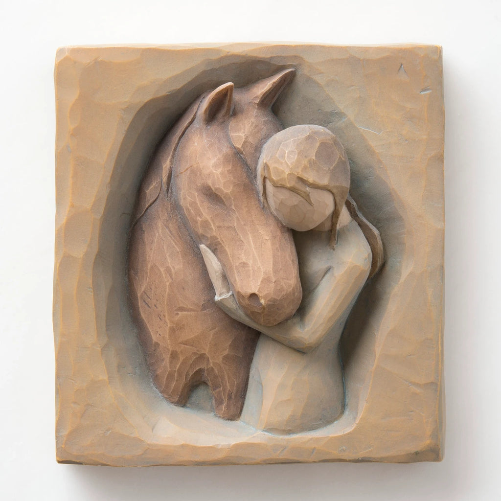 Close front view of wooden plaque carving of horse and little girl figurine hugging it