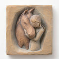 Close front view of wooden plaque carving of horse and little girl figurine hugging it