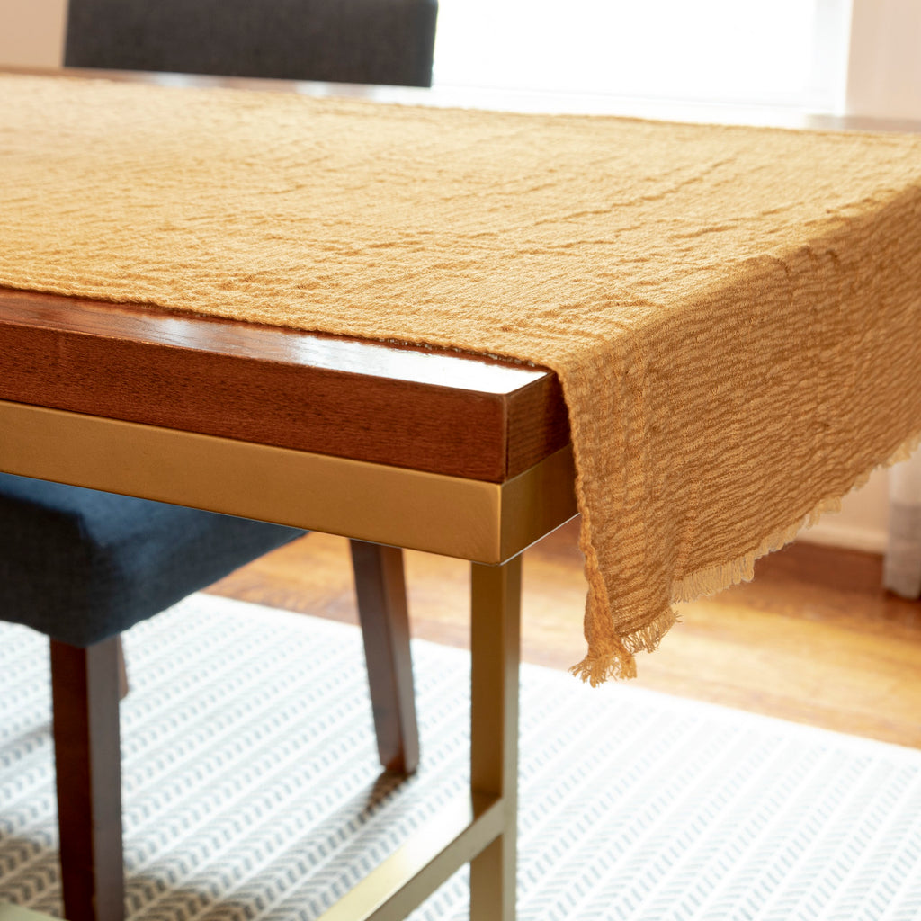 2 ft by 5 ft gauze fabric with gradation of color along length of mustard to sand to mustard, to use under Nativity