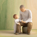 Willow Tree Grandfather, 6”h hand-painted resin figure of seated older man with toddler by his side, both dressed in neutral colors, in front of a green painting