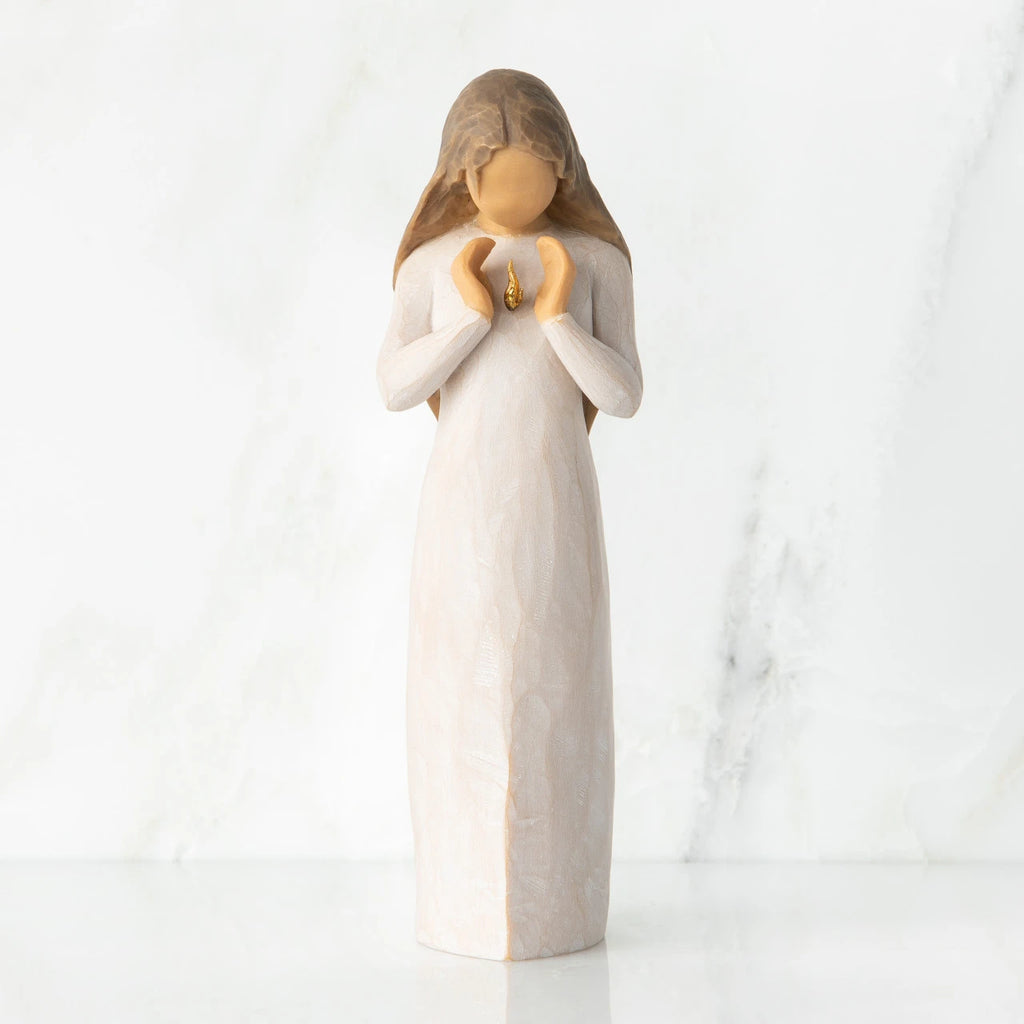 Front view, standing female figure in cream dress, hands surrounding small gold-leaf flame on chest