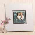 Willow Tree Duet, 10”sq hand-painted dove gray wood frame, with inset bas-relief resin plaque of embracing couple, surrounded by nature, blue ombré background with gold leaf