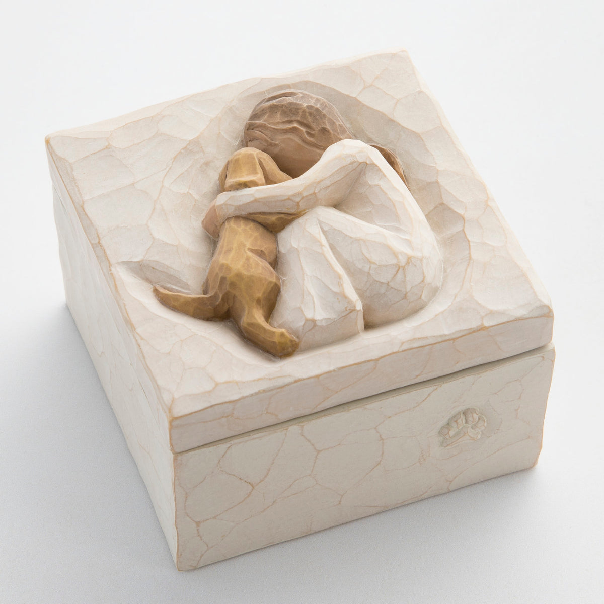 Small cream box with carved in image of girl figurine hugging puppy