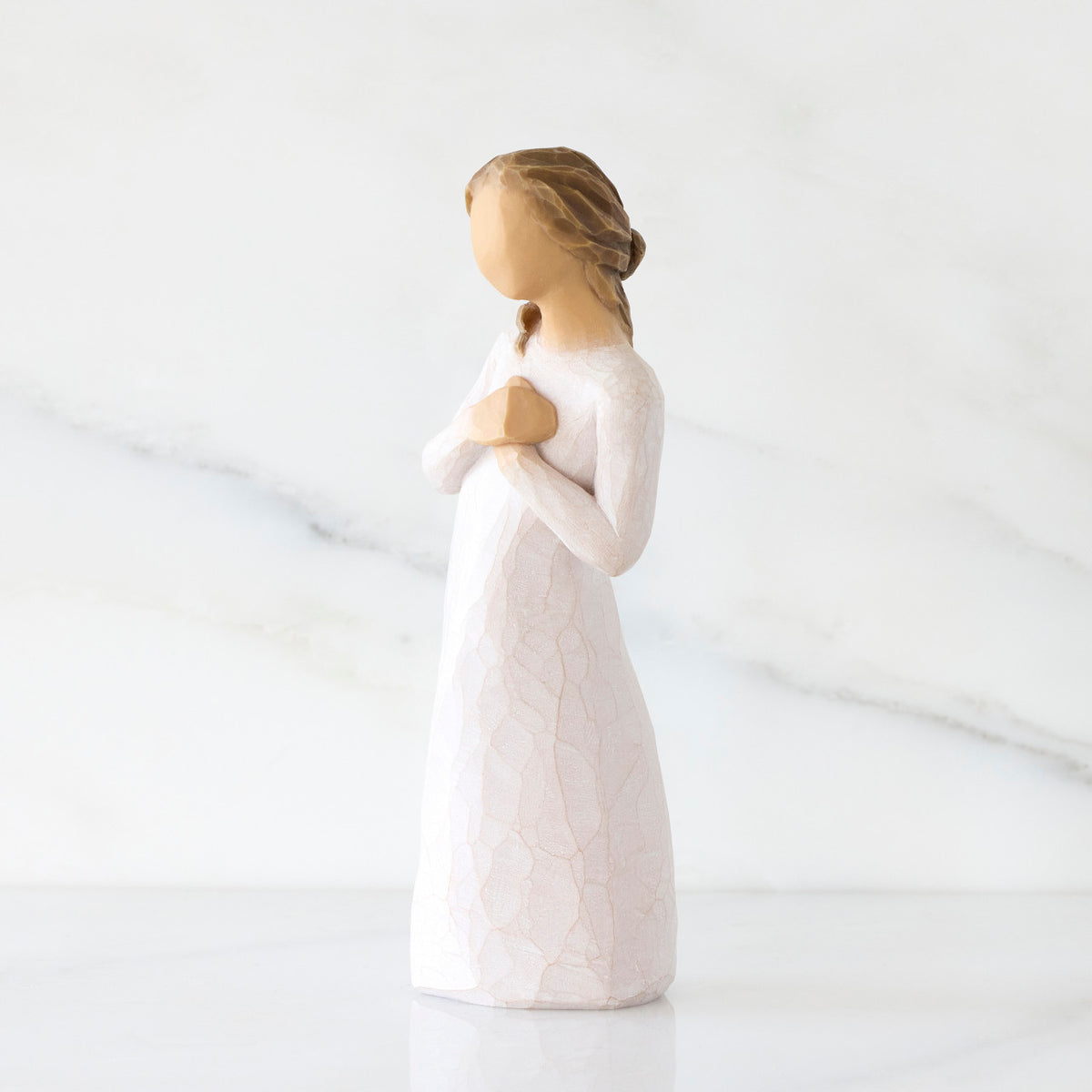 Left-facing view: Standing figure in cream dress with hands to heart in empathetic gesture