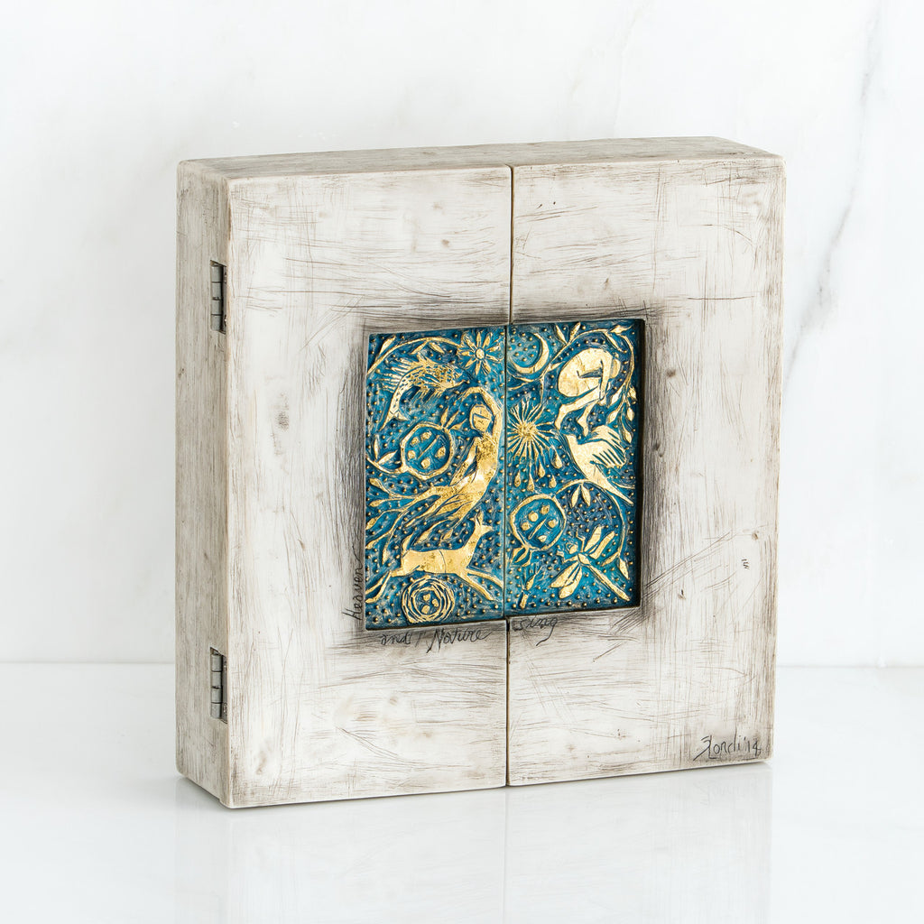 Light grey box with blue and gold scene square in the center