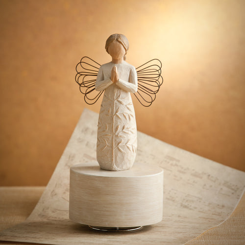 Willow Tree a tree, a prayer Musical, 7.5”h hand-painted resin angel figure in cream dress with wire wings, hands in prayer position, tree carving on dress, atop round, cream base containing musical element, lit in a warm glow