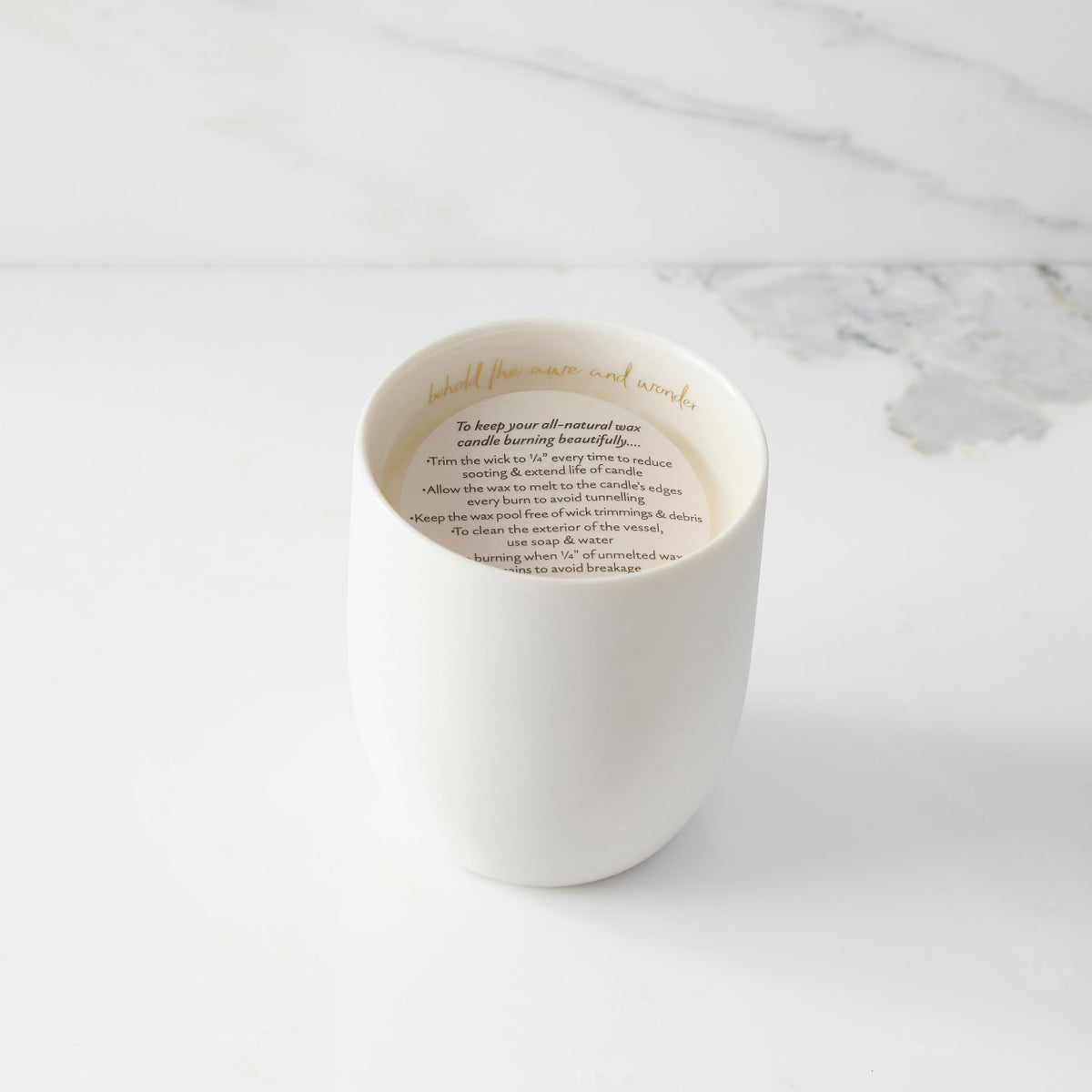 Top view of candle with vellum insert sheet with burning instructions