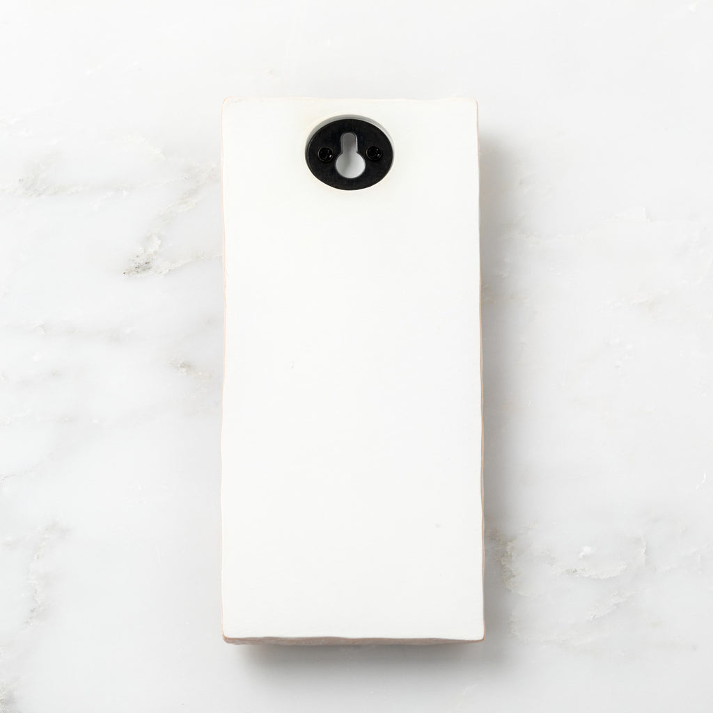 Back of cream plaque with Willow Tree logo, "Embrace" title and "In love's embrace" sentiment, keyhole hanger for wall display