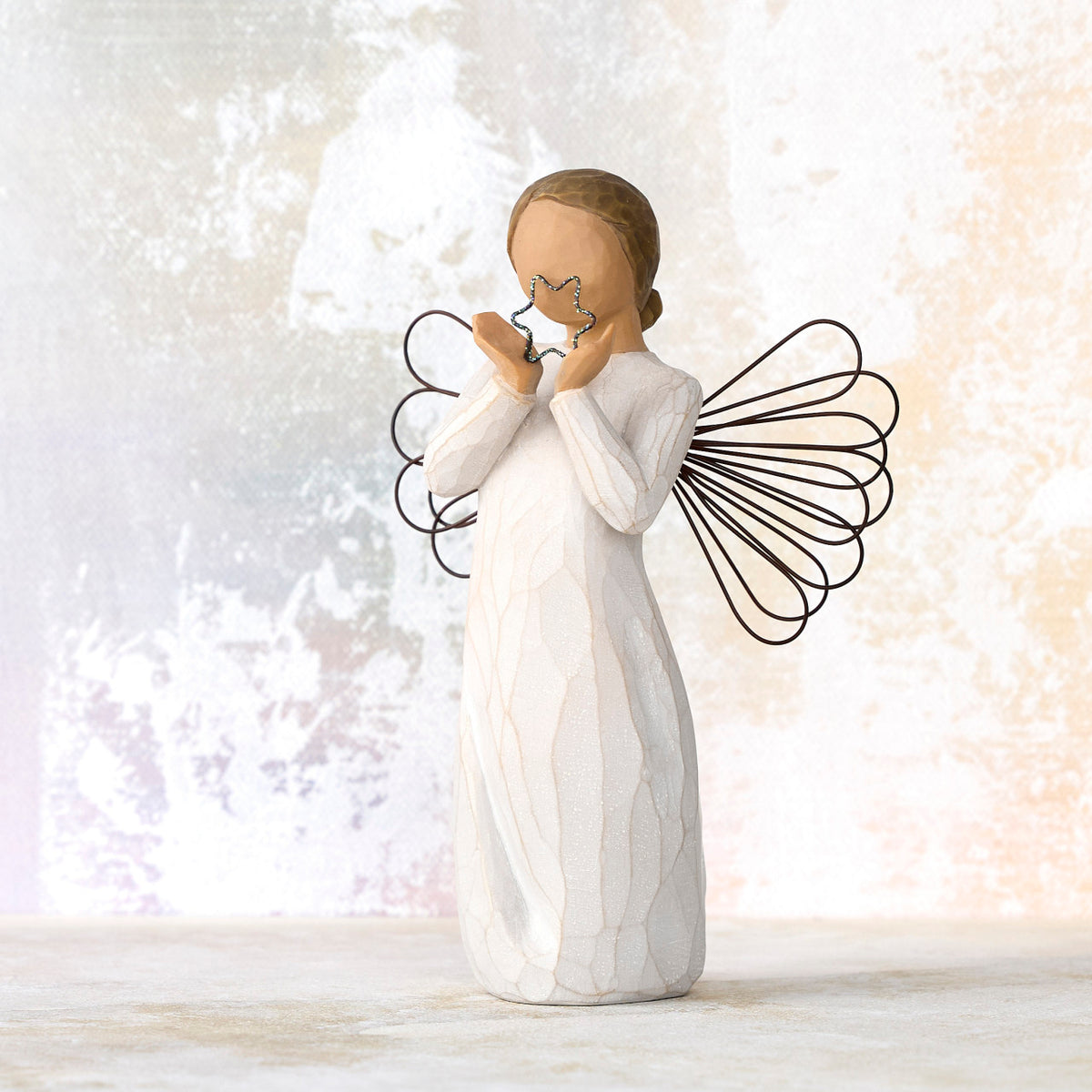 Willow Tree Bright Star, 6”h hand-painted standing resin angel figure in cream dress with wire wings, holding glittered wire star, in front of white painting