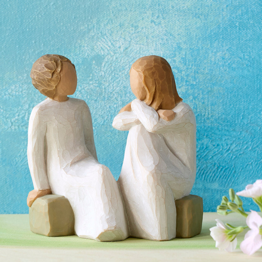 Willow Tree Heart and Soul, 4"h hand-painted resin figure of two women in cream dresses, facing, seated on gray bench, in front of cerulean painting