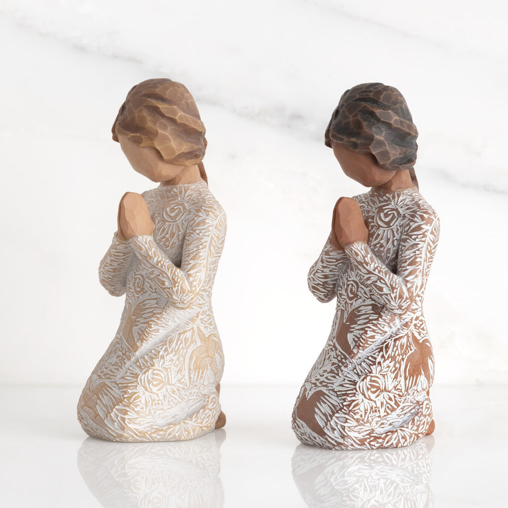Lighter & Darker skin Kneeling figures, hands in position of prayer or meditation in cream dress carved with icons of nature, lighter and darker skin versions