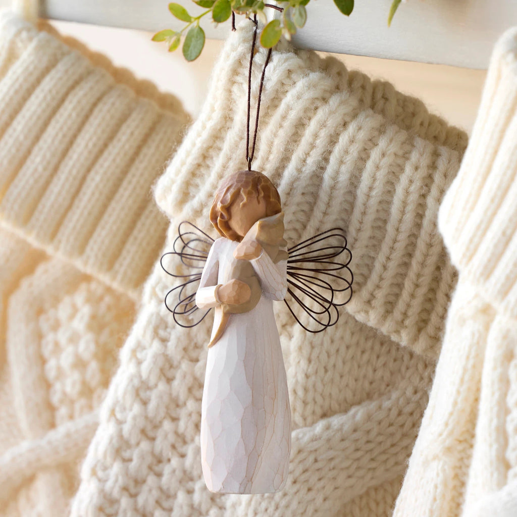 Willow Tree With affection Ornament, 4.5”h hand-painted resin figure in cream dress with wire wings, holding gray cat, brown elastic cord, hanging with cream knitted Christmas stockings