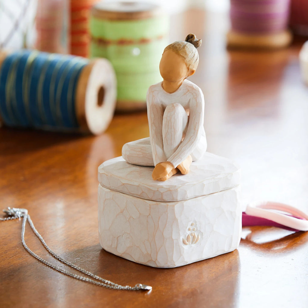 Willow Tree The Dancer Keepsake Box, 3.0"w x 3.25”d hand-painted resin box with 2.25”h figure of seated dancer in cream leotard affixed to lid, on work desk
